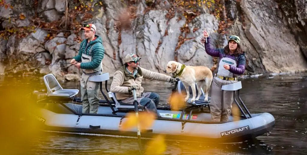 Anglers fly fish with a guide in a scenic stream surrounded by the wooded landscape of Southwest Virginia