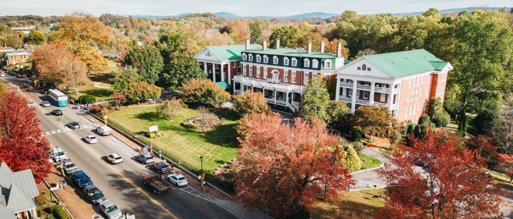 An aerial view of The Martha Washington Inn & Spa in Abingdon, surrounded by the Blue Ridge Mountains and overlooking historic Main Street.