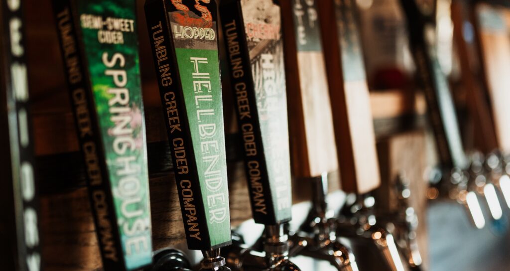 A row of cider tap handles at Tumbling Creek Cider Company, used to pour their locally crafted cider into glasses.